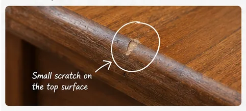 Close-up photo showing a small scratch on the surface of second-hand furniture